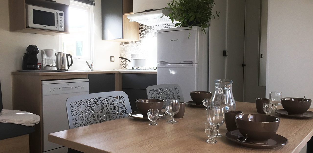 Interior of VIP mobile home with kitchen area and living room, rental accommodation for spa visitors in the Grand-Est region